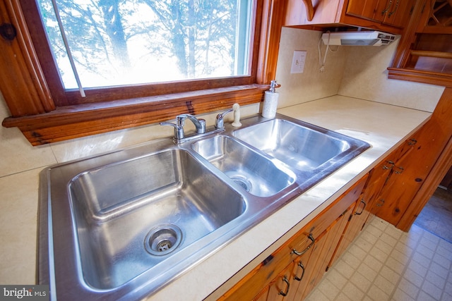 121 E James St, Winchester, VA 22601 - kitchen featuring plenty of natural light, light countertops, brown cabinetry, and light flooring