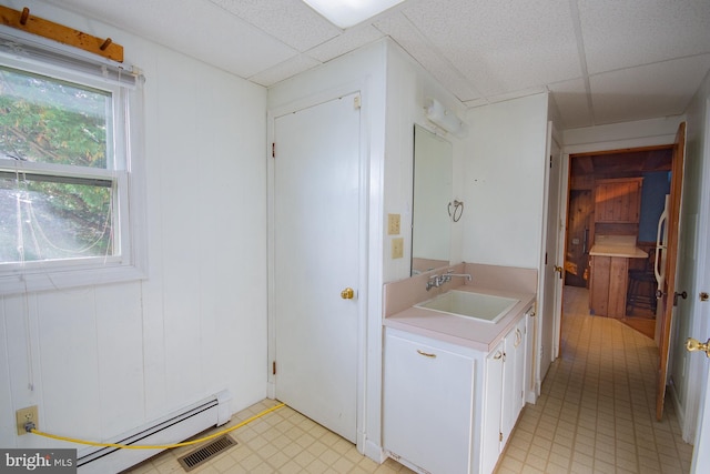 121 E James St, Winchester, VA 22601 - bathroom featuring a drop ceiling, vanity, a baseboard heating unit, and tile patterned floors