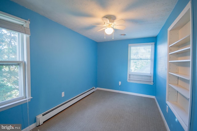 121 E James St, Winchester, VA 22601 - carpeted empty room featuring a baseboard heating unit and ceiling fan