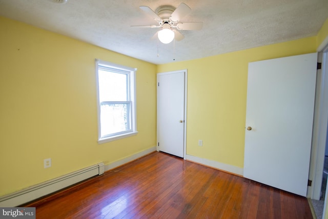 121 E James St, Winchester, VA 22601 - unfurnished bedroom with a baseboard heating unit, wood-type flooring, ceiling fan, and a textured ceiling
