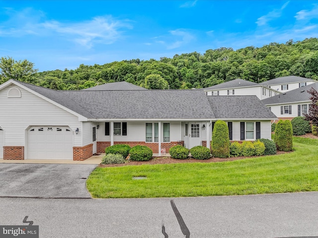 23 Garden Dr, Berkeley Springs, WV 25411 - traditional-style home with brick siding, an attached garage, a porch, a front lawn, and driveway