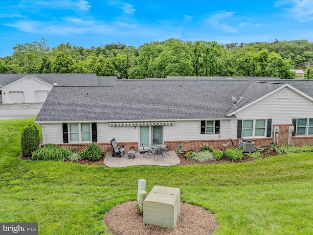 23 Garden Dr, Berkeley Springs, WV 25411 - back of house with brick siding, a yard, a patio, and a shingled roof