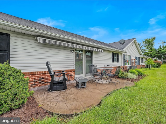 23 Garden Dr, Berkeley Springs, WV 25411 - back of property featuring a patio area, a yard, a shingled roof, and brick siding