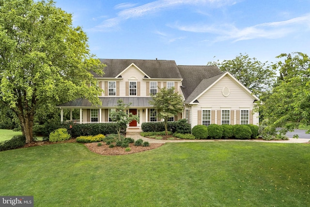 36453 Dwyer Ct, Round Hill, VA 20141 - colonial house with a porch, a front lawn, a standing seam roof, and a metal roof