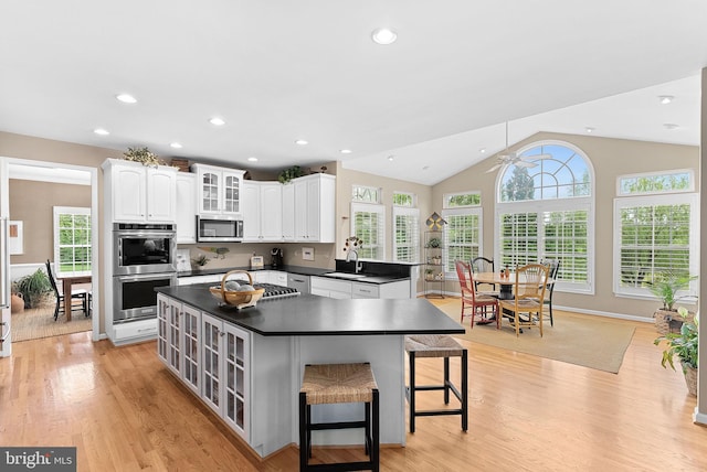 36453 Dwyer Ct, Round Hill, VA 20141 - kitchen with appliances with stainless steel finishes, dark countertops, ceiling fan, light wood-style flooring, and vaulted ceiling