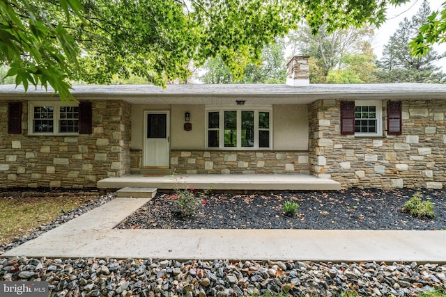 1363 Byberry Rd, Huntingdon Valley, PA 19006 - ranch-style house with stone siding, a chimney, and a porch