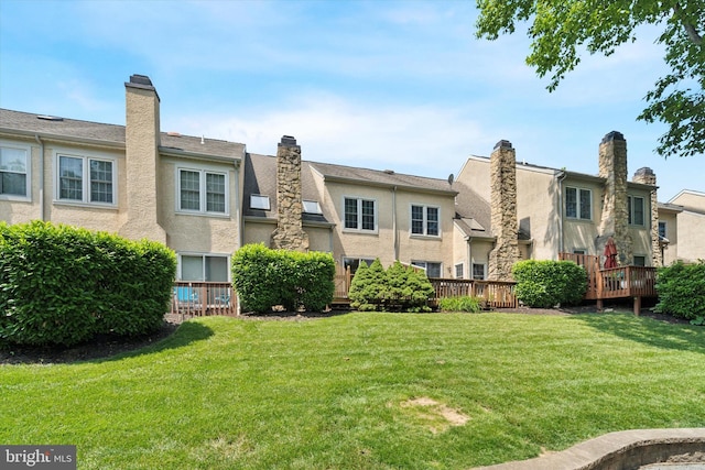 1305 Halifax Ct Unit 1305, West Chester, PA 19382 - rear view of house featuring stucco siding, a lawn, a deck, and a residential view