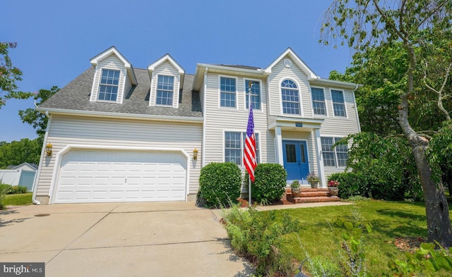 34 N Erin Ave, Felton, DE 19943 - colonial home featuring driveway, roof with shingles, a front yard, and a garage