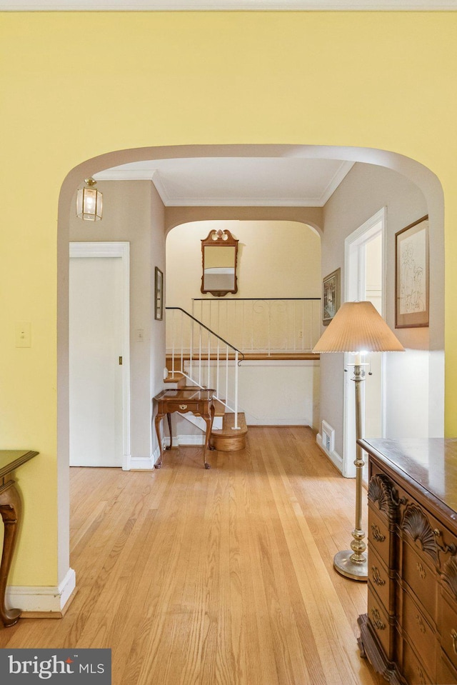 3917 Fessenden St NW, Washington, DC 20016 - entryway with arched walkways, crown molding, light wood-type flooring, and stairway