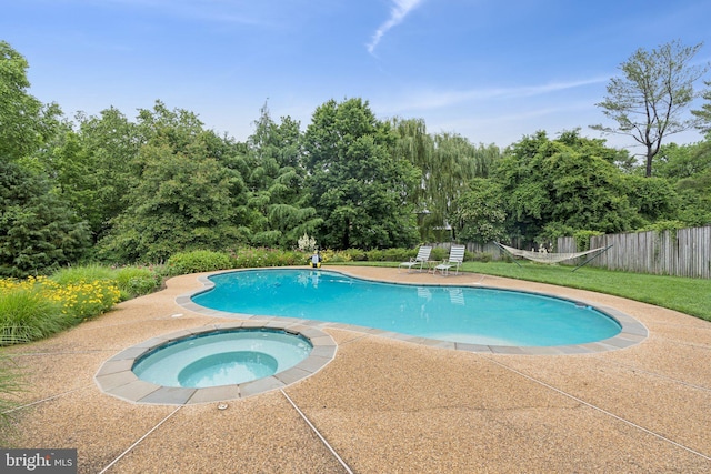 3917 Fessenden St NW, Washington, DC 20016 - view of pool with an in-ground hot tub, a patio, and view of scattered trees