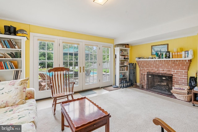 3917 Fessenden St NW, Washington, DC 20016 - carpeted living room featuring french doors and a brick fireplace