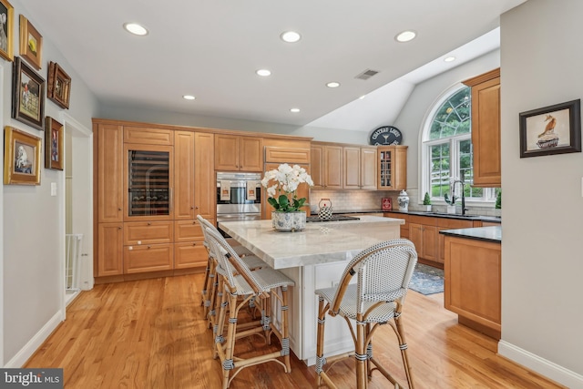 10 Callery Way, Malvern, PA 19355 - kitchen with a kitchen island, recessed lighting, light wood-style floors, backsplash, and a breakfast bar area