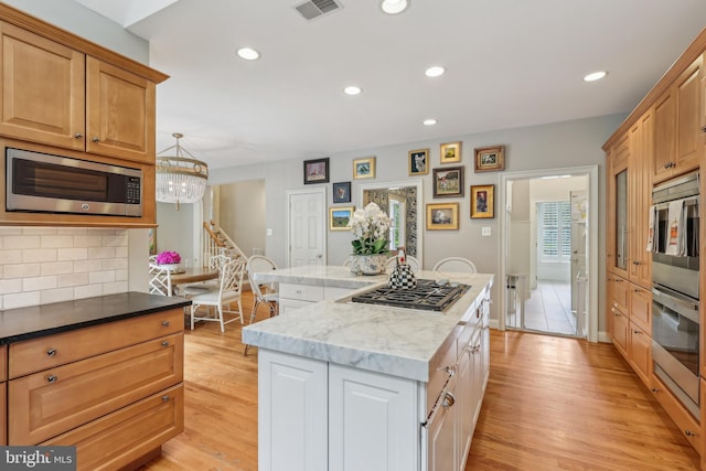 10 Callery Way, Malvern, PA 19355 - kitchen featuring appliances with stainless steel finishes, a center island, light wood-style floors, recessed lighting, and tasteful backsplash