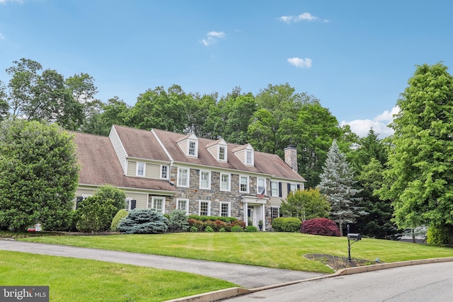 10 Callery Way, Malvern, PA 19355 - view of front of house with a front yard, stone siding, and a chimney