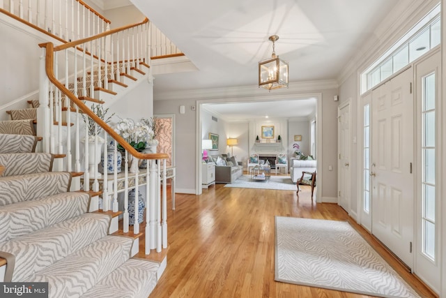 10 Callery Way, Malvern, PA 19355 - foyer with stairway, light wood-type flooring, a chandelier, and crown molding