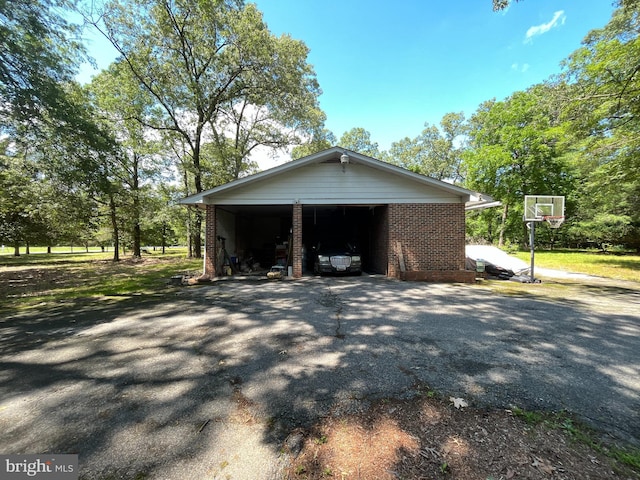 14102 Gibbons Church Rd, Brandywine, MD 20613 - view of side of property featuring asphalt driveway, brick siding, and a carport