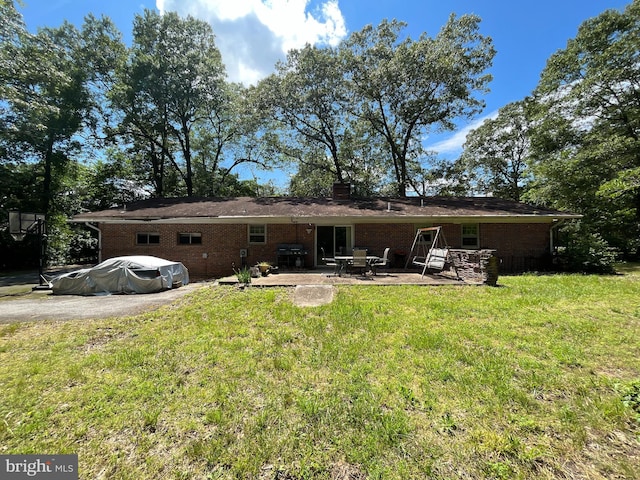 14102 Gibbons Church Rd, Brandywine, MD 20613 - rear view of house featuring a patio area, a lawn, and brick siding