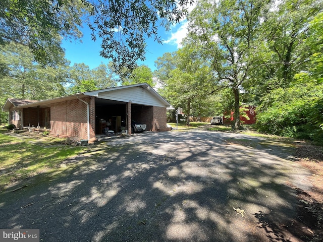 14102 Gibbons Church Rd, Brandywine, MD 20613 - view of side of property with brick siding, driveway, and a carport
