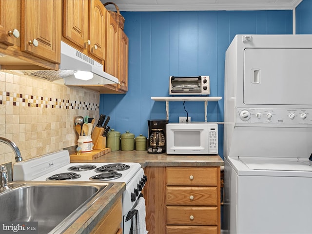 2701 Sparrow Ln Unit 1, Ocean City, MD 21842 - kitchen featuring white appliances, stacked washer / dryer, backsplash, brown cabinetry, and under cabinet range hood