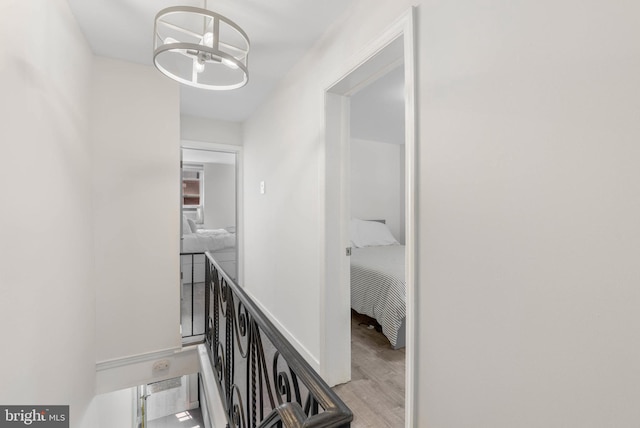 2229 S Darien St, Philadelphia, PA 19148 - corridor with wood finished floors, an upstairs landing, and a chandelier