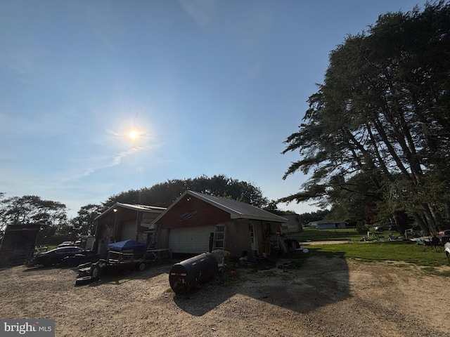 242 Center Rd, Elmer, NJ 08318 - view of property exterior featuring a garage, an outdoor structure, and dirt driveway