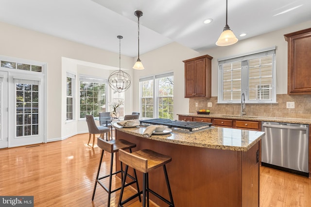 4509 Rhett Ln, Fairfax, VA 22030 - kitchen with stainless steel appliances, decorative backsplash, a chandelier, light wood-type flooring, and decorative light fixtures