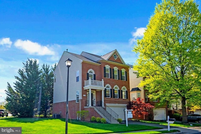 4509 Rhett Ln, Fairfax, VA 22030 - colonial-style house featuring a balcony, a garage, a front lawn, and brick siding