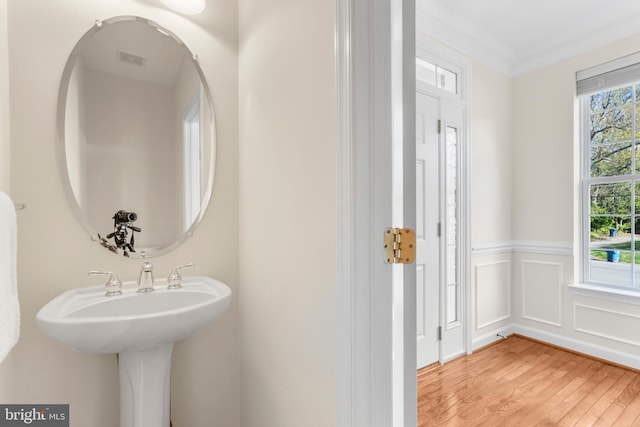 4509 Rhett Ln, Fairfax, VA 22030 - bathroom featuring wood finished floors, a wainscoted wall, and crown molding