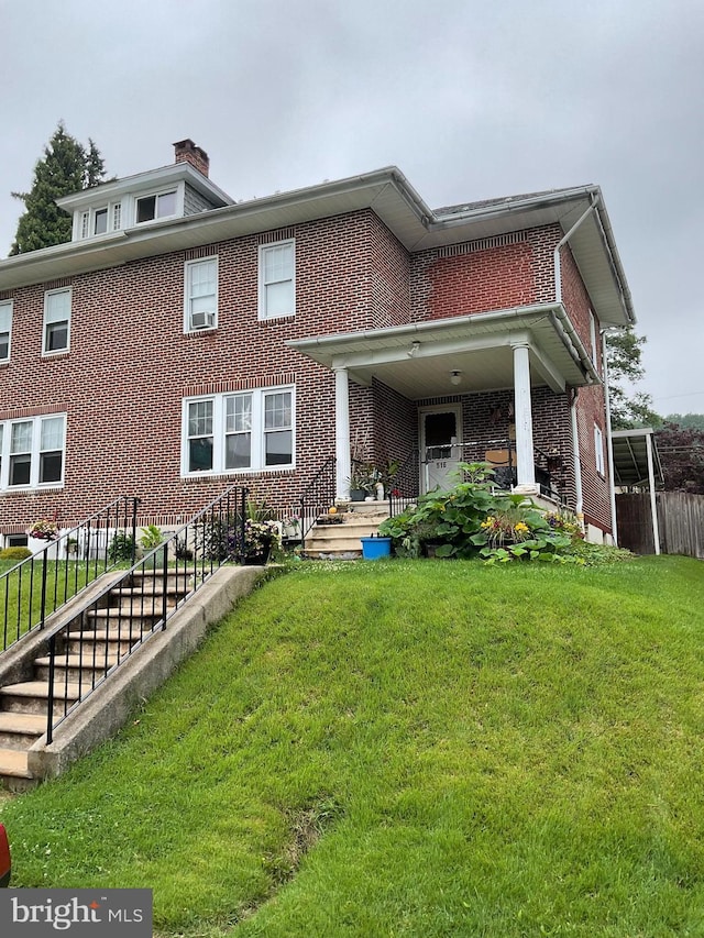 516 N 25th St, Reading, PA 19606 - view of front of home featuring brick siding and a chimney