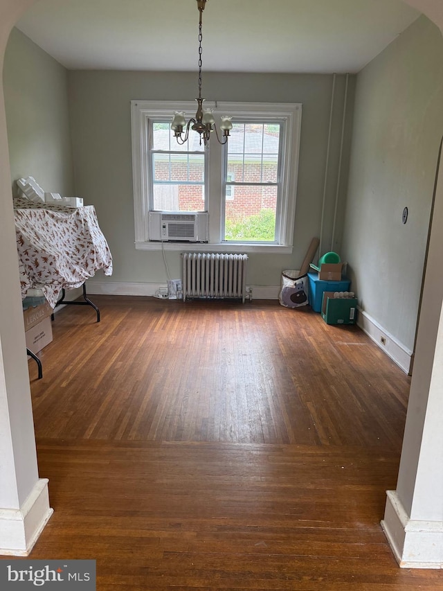 516 N 25th St, Reading, PA 19606 - dining room with radiator heating unit, wood-type flooring, a chandelier, and cooling unit