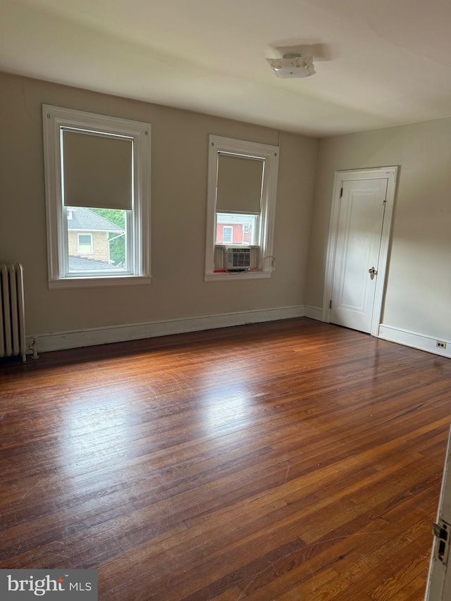 516 N 25th St, Reading, PA 19606 - empty room featuring radiator heating unit and dark wood-style flooring