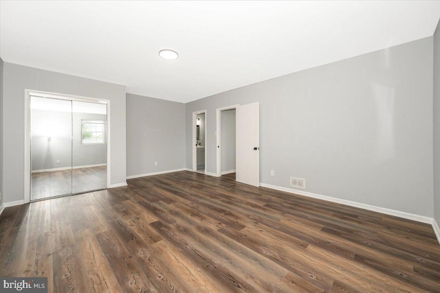 7533 Dover Ln, Lanham, MD 20706 - unfurnished bedroom featuring dark wood-type flooring and a closet