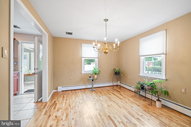 532 Wicker Ave, Bensalem, PA 19020 - spare room with light wood-style flooring, a chandelier, and a baseboard radiator