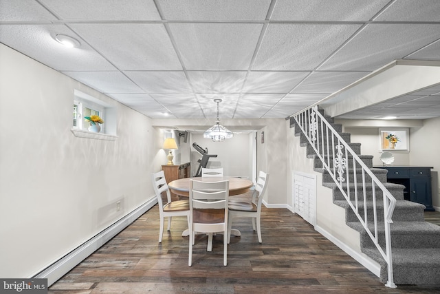 532 Wicker Ave, Bensalem, PA 19020 - dining space featuring a baseboard heating unit, stairs, dark wood-type flooring, and a paneled ceiling