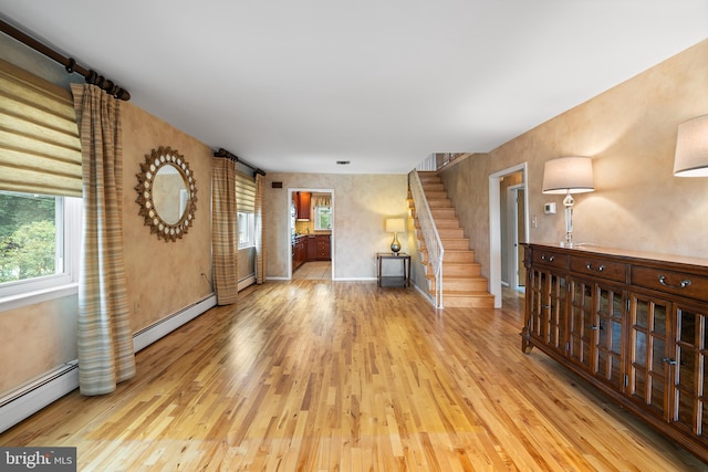 532 Wicker Ave, Bensalem, PA 19020 - unfurnished living room featuring baseboard heating, wood finished floors, and healthy amount of natural light