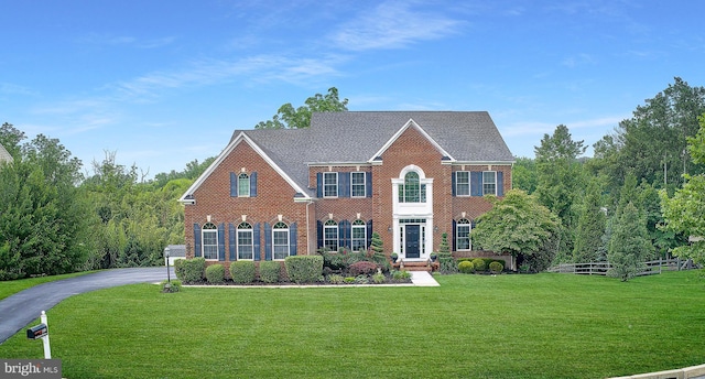 1103 Judson Dr, West Chester, PA 19380 - colonial house with brick siding, a front yard, and a shingled roof