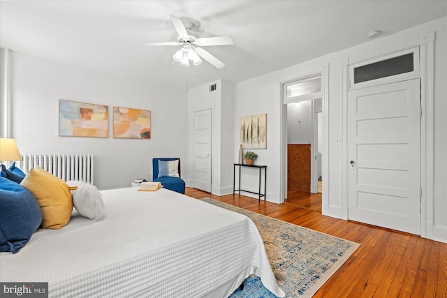 2637 Garfield St NW, Washington, DC 20008 - bedroom with radiator, hardwood / wood-style flooring, and a ceiling fan
