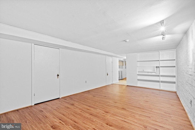 2637 Garfield St NW, Washington, DC 20008 - unfurnished living room with wood finished floors, rail lighting, and built in shelves