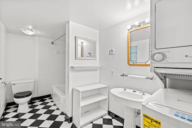 2637 Garfield St NW, Washington, DC 20008 - bathroom with tile patterned floors, stacked washer / dryer, and  shower combination