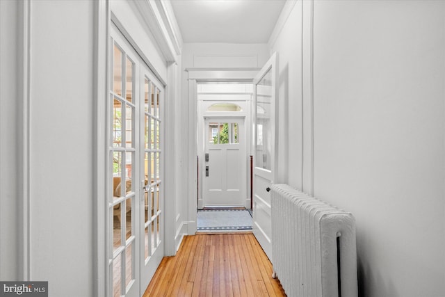 2637 Garfield St NW, Washington, DC 20008 - doorway with radiator heating unit, light wood-style floors, and french doors