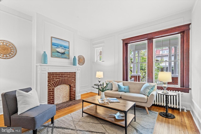 2637 Garfield St NW, Washington, DC 20008 - living area with radiator heating unit, wood-type flooring, and a fireplace