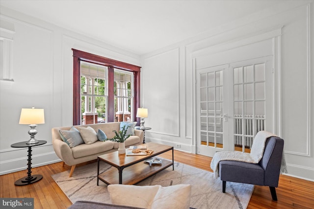 2637 Garfield St NW, Washington, DC 20008 - living room featuring a decorative wall, wood-type flooring, and french doors