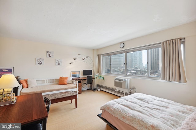 2101 Chestnut St Unit 909, Philadelphia, PA 19103 - bedroom featuring light wood-type flooring, an AC wall unit, and a desk