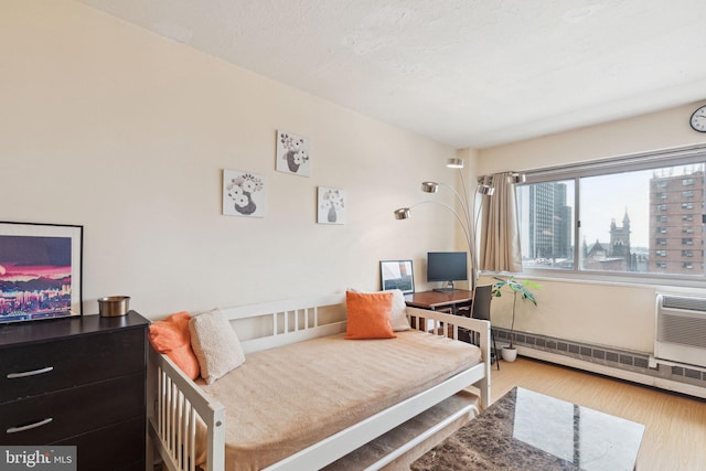2101 Chestnut St Unit 909, Philadelphia, PA 19103 - bedroom featuring wood finished floors and a baseboard radiator