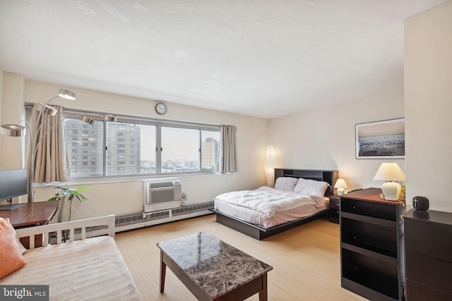 2101 Chestnut St Unit 909, Philadelphia, PA 19103 - bedroom featuring wood finished floors, a baseboard heating unit, and a wall unit AC