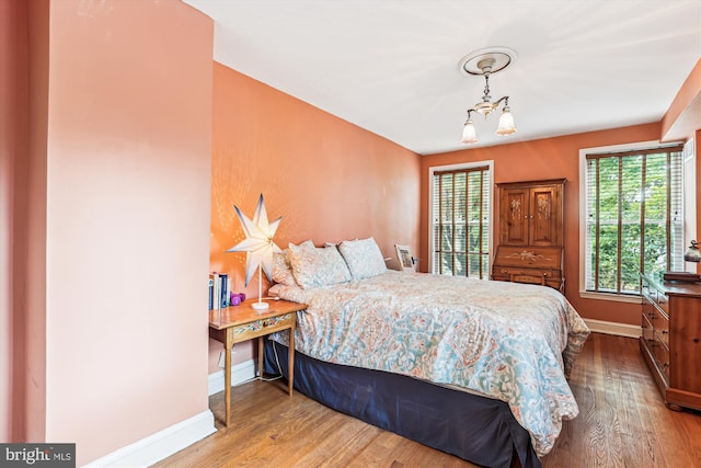 423 5th St SE, Washington, DC 20003 - bedroom featuring wood finished floors and a chandelier