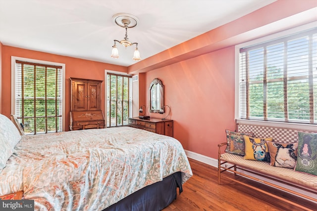 423 5th St SE, Washington, DC 20003 - bedroom featuring multiple windows, a chandelier, and wood finished floors
