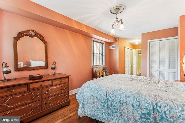423 5th St SE, Washington, DC 20003 - bedroom with dark wood-style flooring and two closets