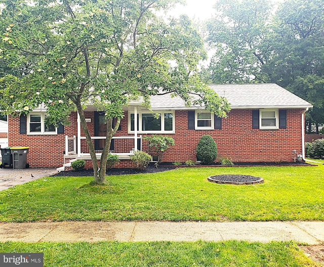 207 Maryland Ave, Newport, DE 19804 - view of front of house with brick siding and a front yard