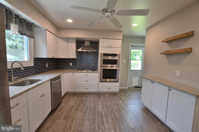 207 Maryland Ave, Newport, DE 19804 - kitchen featuring stainless steel appliances, wall chimney exhaust hood, white cabinetry, and recessed lighting